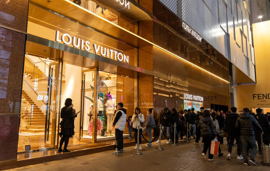 Shoppers queue outside the Louis Vuitton store in Tsim Sha Tsui, Kowloon, Hong Kong.